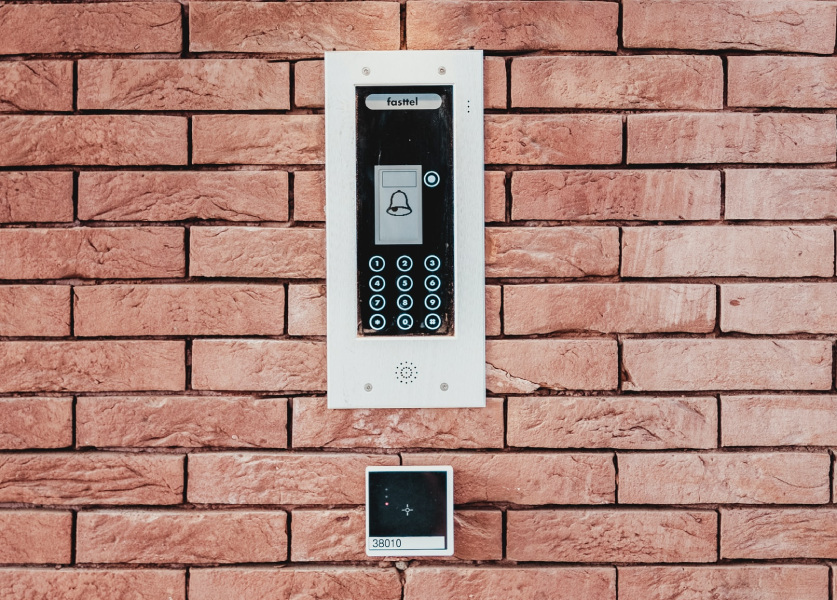 A brick wall with a black and white phone on it