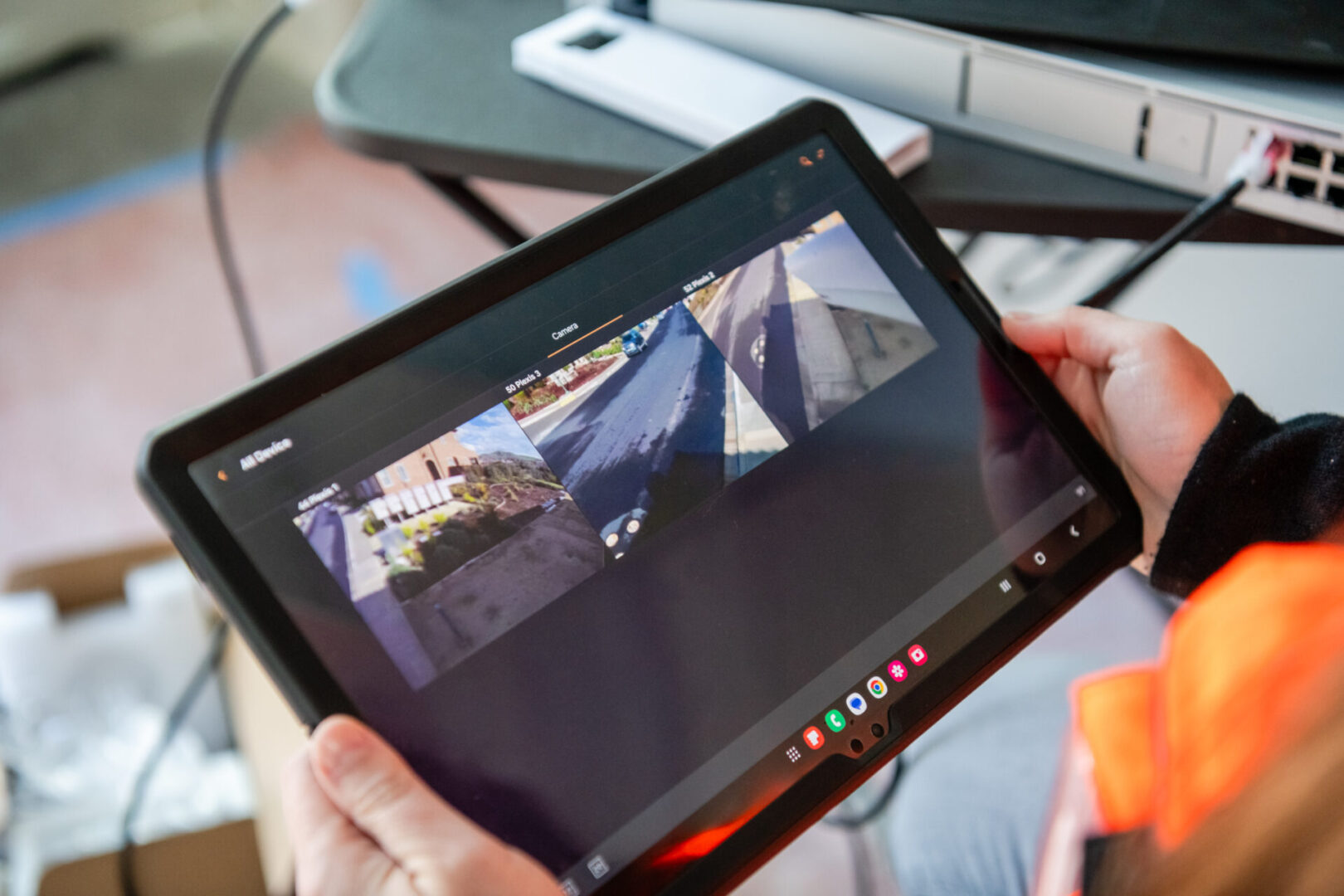 A person holding an open tablet in their hands.