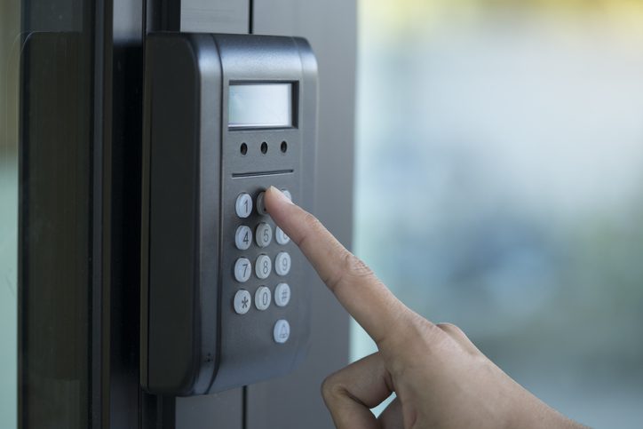 A person is pressing the button on a door.